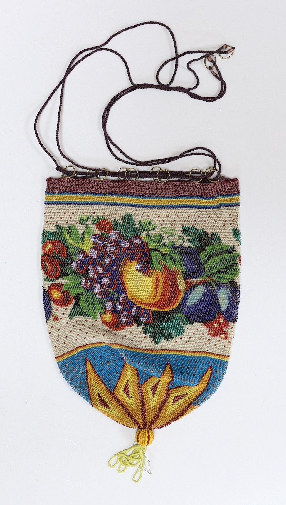 An unusual finely beaded early 19th century draw string bag, decorated with a wide band of multi coloured fruits and leaves.